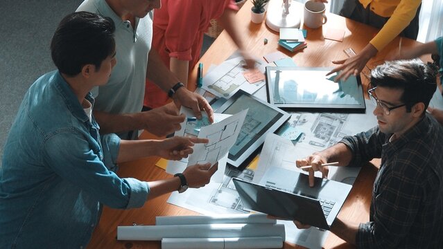 Time lapse of civil engineer team working together to plans building construction. Top view of architect designer walking and joining meeting while talking idea while looking at tablet. Symposium.