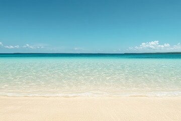 Obraz premium A serene tropical beach scene with pristine white sand and crystal clear turquoise water. The sky is a vibrant blue with a few fluffy clouds, creating a sense of peace and relaxation.