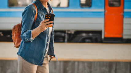 close up of woman hand use cellphone and walk with suitcase