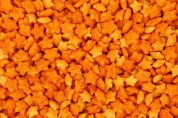 Chips with paprika flavor in star shape. Background. Top view.