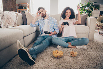 Fototapeta premium Full size photo of two nice young partners play video games weekend modern apartment indoors