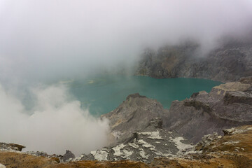 Mysterious scene of a volcanic lake under a cloudy sky, emitting steam, creating an eerie atmosphere