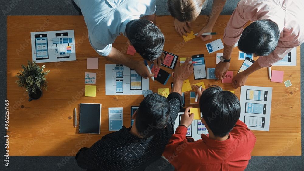 Fototapete top down view of business team writing idea on sticky note while planing for ux ui design for mobile