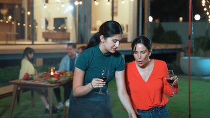 Family gather celebrate holiday. Focus Mother and grandmother drink wine and grill food for family...