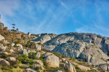 Rock, environment and landscape with mountain in nature for ecology, sustainability and growth. Habitat conservation, ecosystem preservation and biodiversity with blue sky and travel for ecotourism