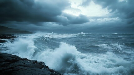 Obraz premium Dramatic stormy seascape with large waves crashing on a rocky shore under a moody, overcast sky.