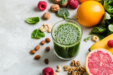 Fresh green smoothie with healthy ingredients, on a white background
