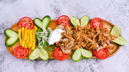 Delicious porion doner kebab with fries and vegetables