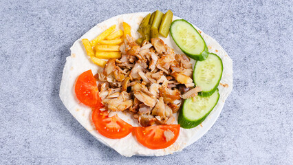 Delicious porion doner kebab with fries and vegetables