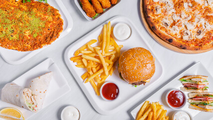 Delicious burger and French fries top view