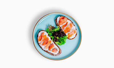 Bruschetta with salmon and cheese in blue plate isolated on white top view
