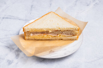 Sliced club sandwich on paper