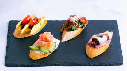 Different sorts of bruschetta on tray