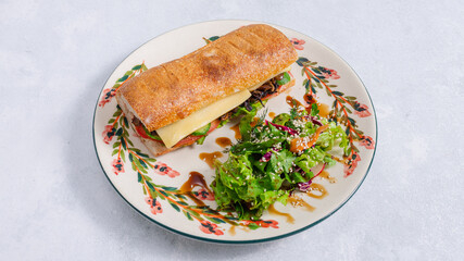 Italian sandwich and greens on plate