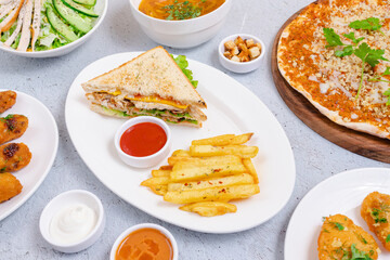 Sliced club sandwich and fries