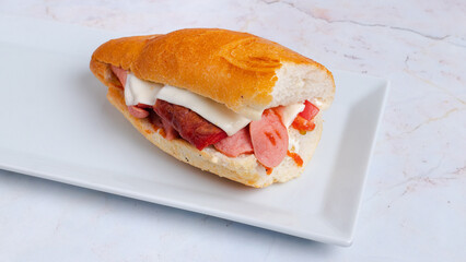Sausage and ham sandwich on plate
