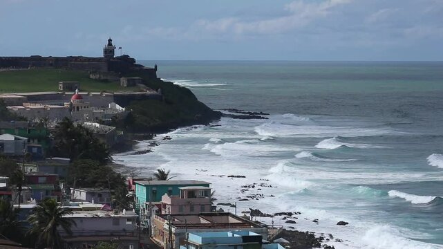 view of el morro spanish fort in old san juan puerto rico with caribbean sea and la perla residential community in the foreground (tropical island travel destination) tourism