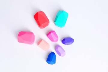 Many colorful balancing stones on white background, flat lay