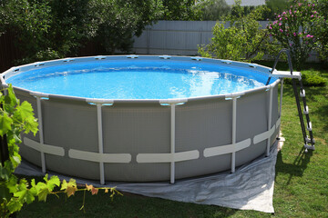 Above ground swimming pool outdoors on sunny day