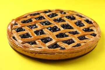 Tasty homemade pie with blueberries on yellow table, closeup