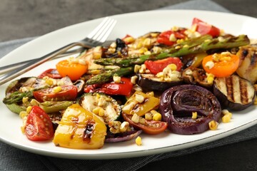 Delicious salad with grilled vegetables served on gray table, closeup