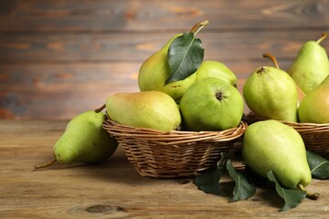 Fresh green pears and leaves on wooden table, closeup