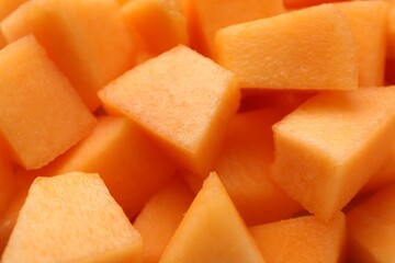 Pieces of Cantaloupe melon as background, top view