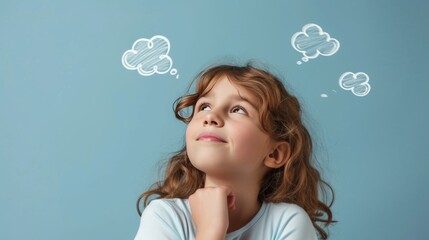 A young girl with light brown hair looks up thoughtfully at chalk clouds drawn on a pastel blue wall. The image beautifully captures her imagination and the quiet, introspective mood of childhood
