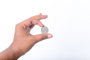 Rupiah coins, hand holding several rupiah coins on a white background.