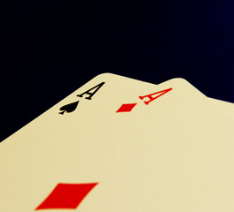 Pair of aces playing cards laid on black background.