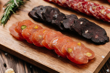 Sliced sausage with pistachios on wooden board, ideal for food presentations and gourmet displays