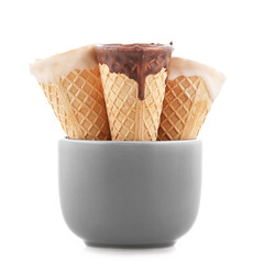 Molten ice cream cones in ceramic bowl isolated on white