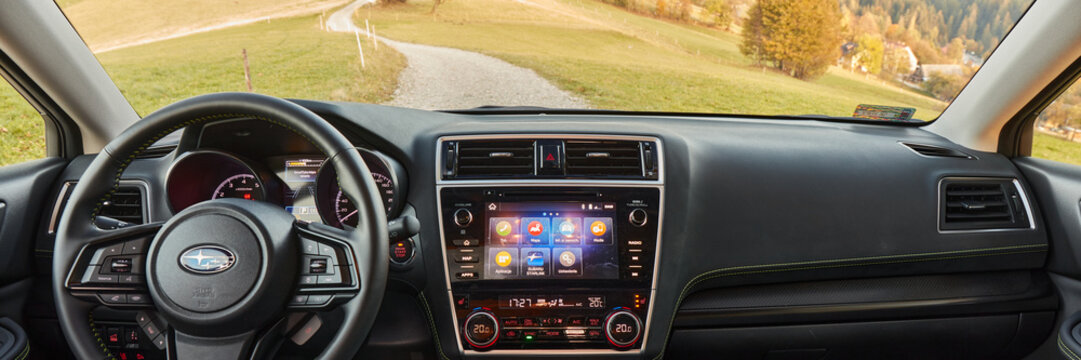 The interior and dashboard of a Subaru Outback driving on a mountain road. 2019 model, 175 HP engine. Wisla, Poland - 10.13.2019