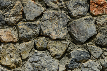 Stone wall texture background - grey stone siding with different sized stones