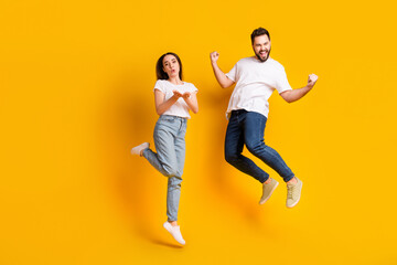 Full size photo of pretty young male female excited jump celebrate wear trendy white outfit...