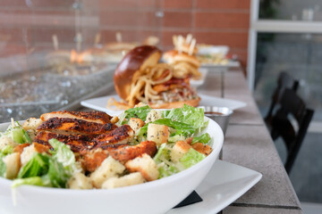Caesar salad with blackened chicken, romaine lettuce, parmesan, and croutons