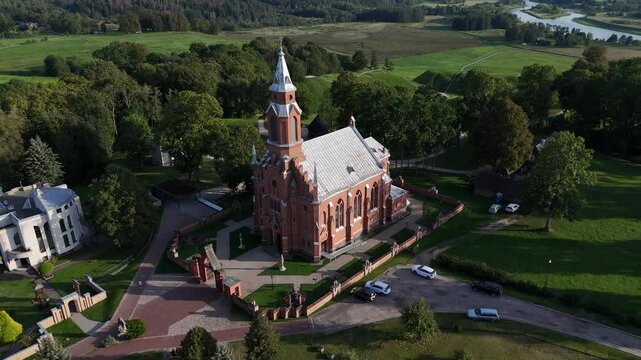 Aerial view of Kernave church and Neris river valley in Lithuania. Aerial view of the historic Kernave church with the Neris river valley in the background, surrounded by lush greenery in Lithuania.