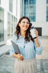 Fototapeta premium Young successful woman is going to work at modern business building 