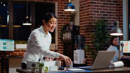Woman dancing and singing while packing desk belongings, excited to change offices after job promotion. Joyful employee being advanced in company hierarchy, celebrating, saluting colleague, camera B