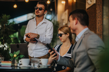 Young professionals engage in casual discussion at an outdoor cafe. They utilize mobile devices and laptops, fostering a relaxed meeting atmosphere under stylish string lighting.