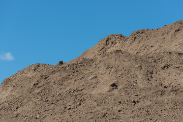 blue sky and soil mound at a construction site