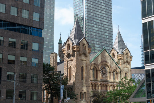 wide view of St Andrew's Church located at 73 Simcoe Street (King Street West), a historic Presbyterian place of worship, designed by William George Storm in Romanesque Revival, 1876 (Toronto, ON)
