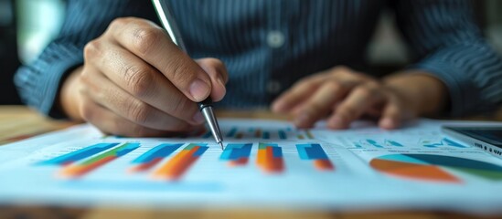 Fototapeta premium Financial data analysis with colorful charts and graphs on desk in a professional business office setting representing financial planning strategy decision making and analytics