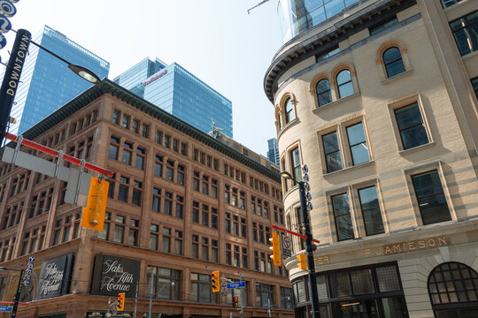 looking southwest to intersection of Yonge St and Queen St W (Saks Fifth Avenue, 176 Yonge St and historic property at 2 Queen St W) in downtown Toronto, Canada 