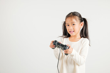 Asian happy portrait young kid girl smile lifestyle games technology holding joystick game playing on hands studio shot isolated white background with copy space, kindergarten child relaxation time