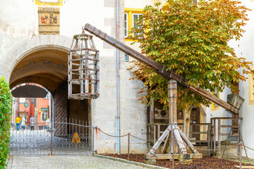 A medieval wooden gibbet cage is suspended above ground near the Museum of Torture in the Bavarian...