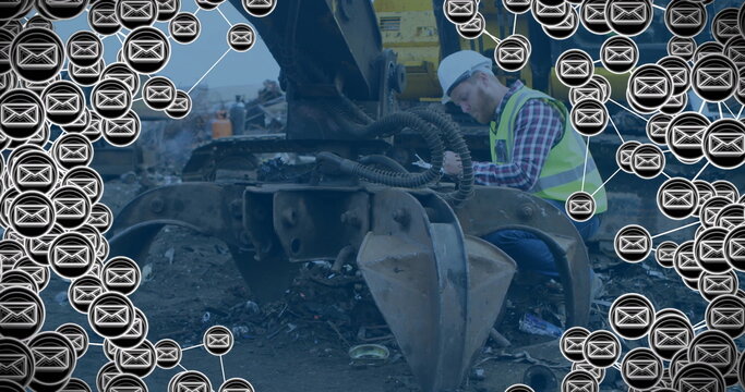 Image of envelope icons over caucasian male worker at building site - Powered by Adobe