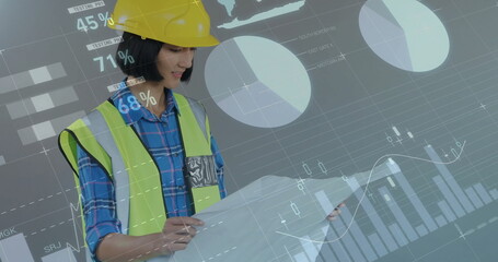 Image of financial data processing over biracial female architect using tablet