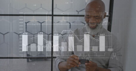 Image of diagrams and data processing over biracial businessman using smartphone