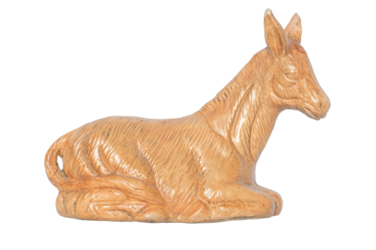 Figure of a golden donkey lying down. Animals of the field. Figure of a manger.